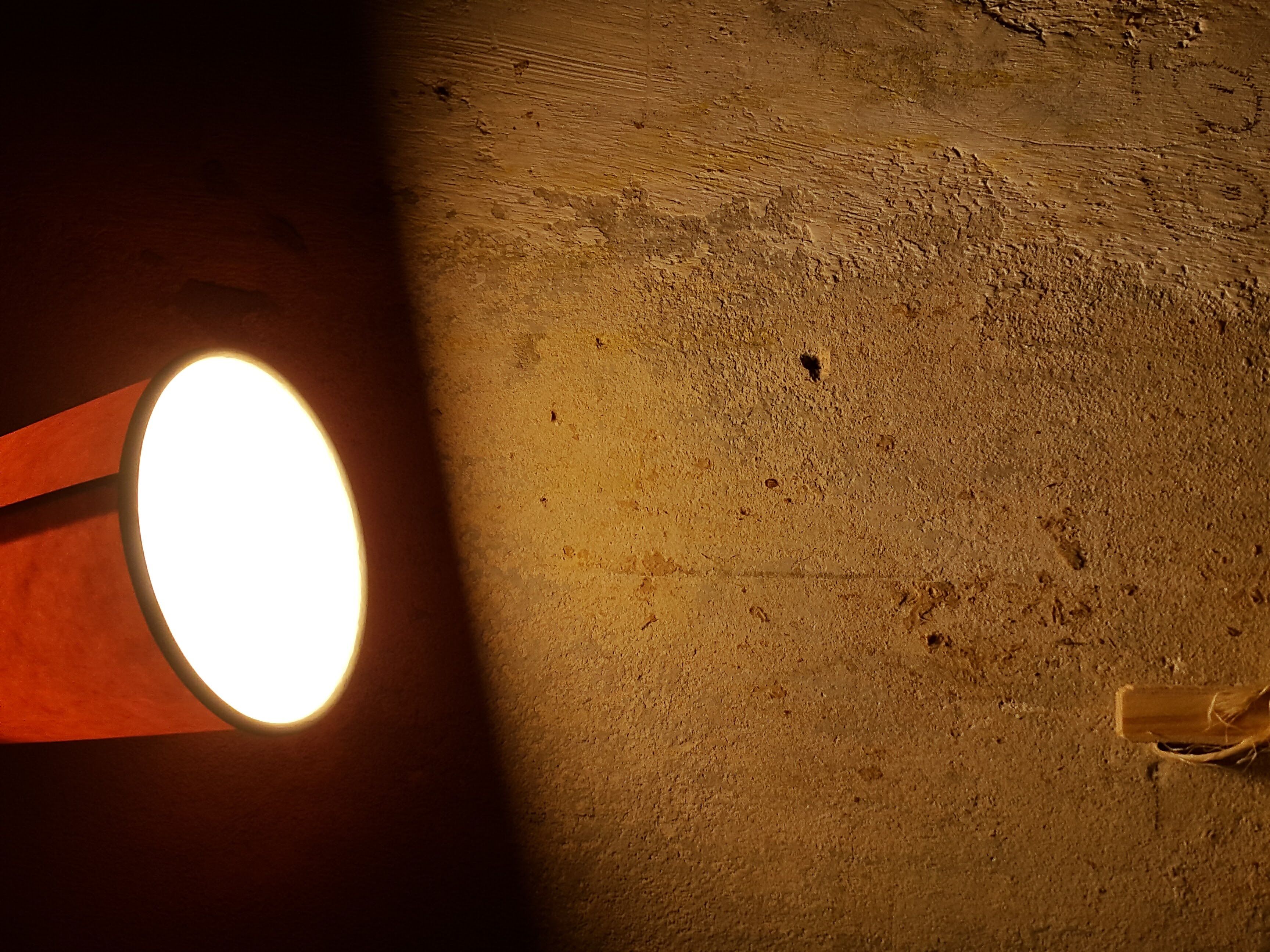 an old lamp illuminating a wall