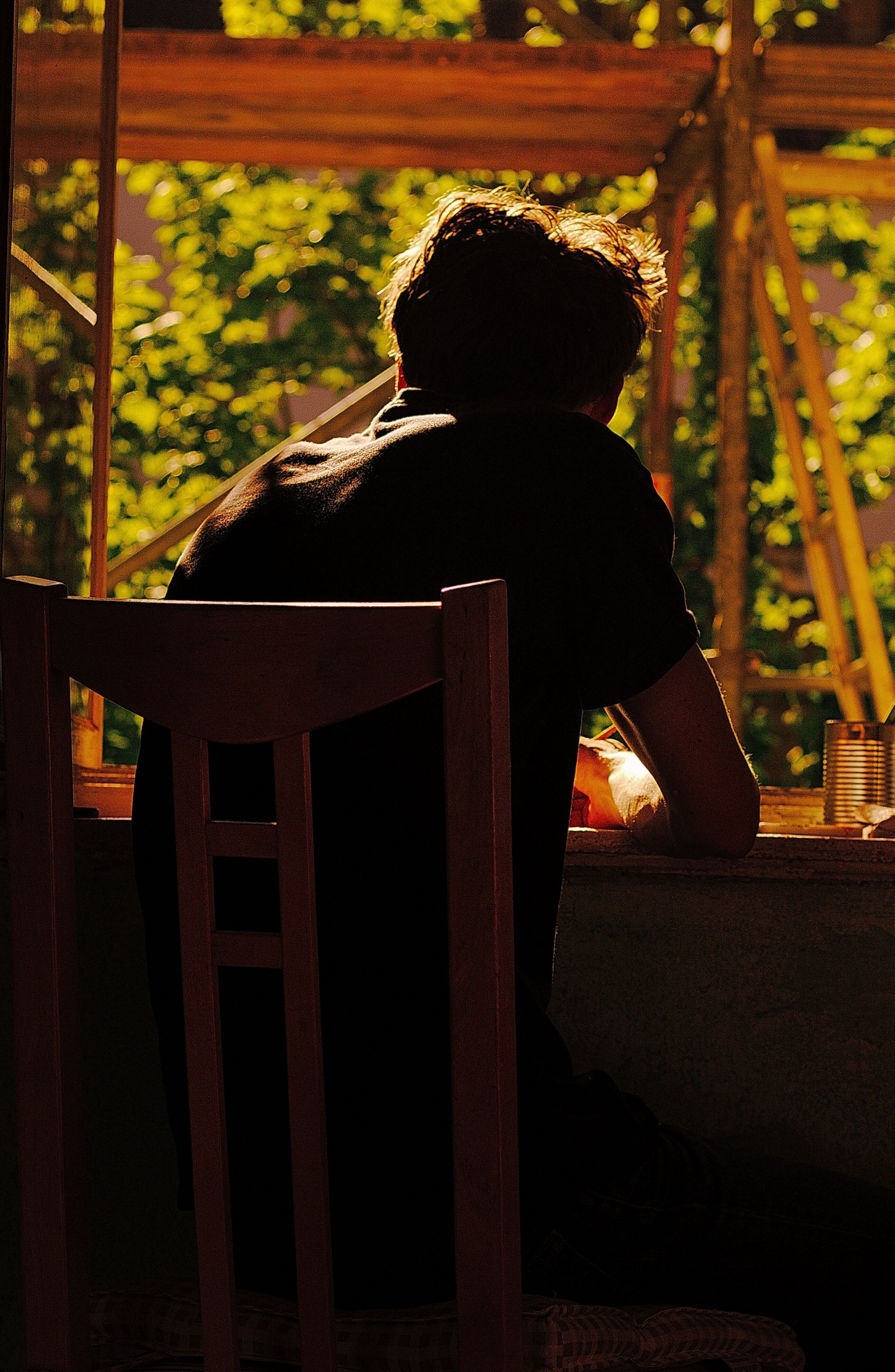 person sitting at a window, drawing